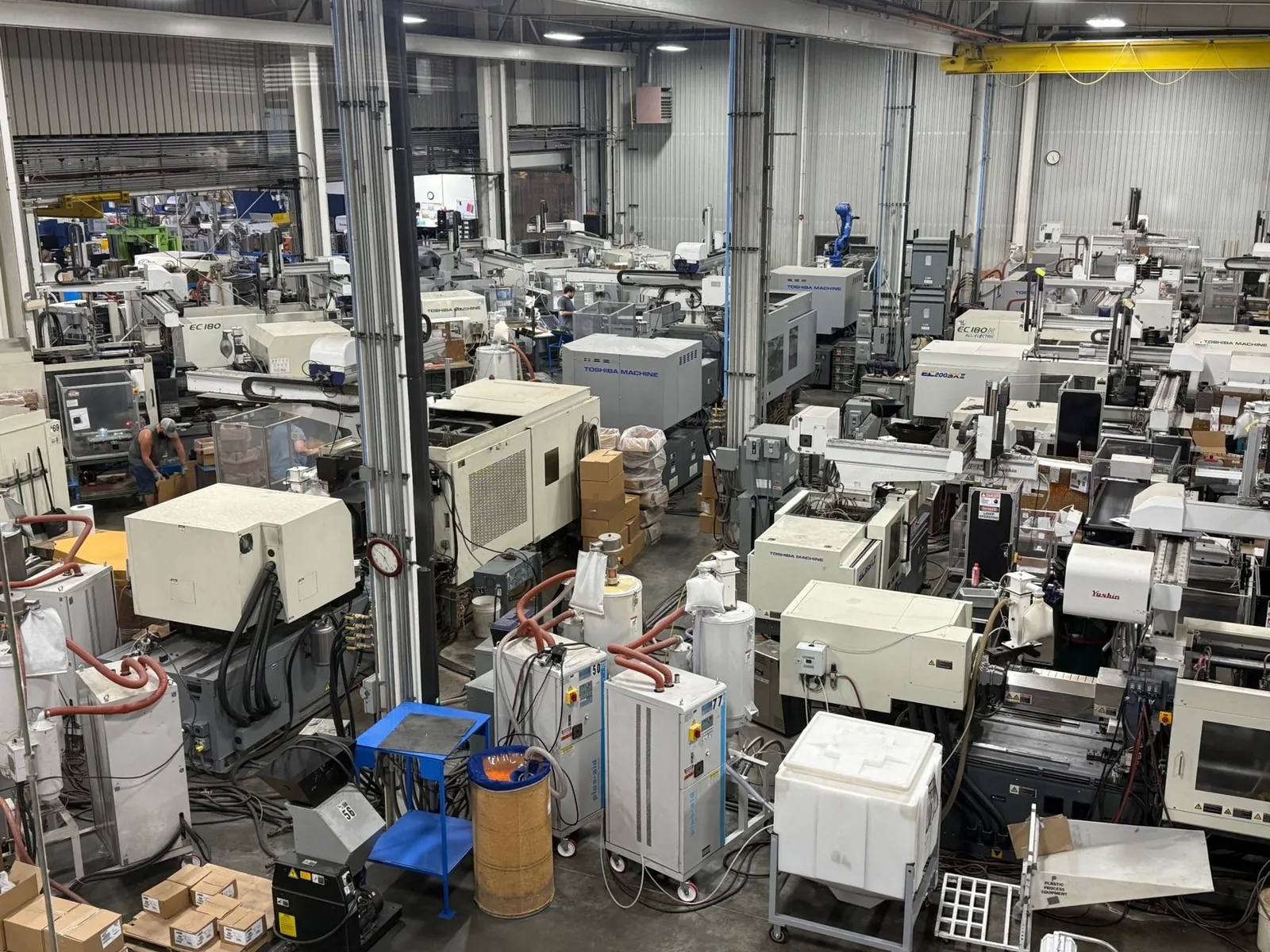 PRD molding floor with rows of Toshiba injection molding presses and robots